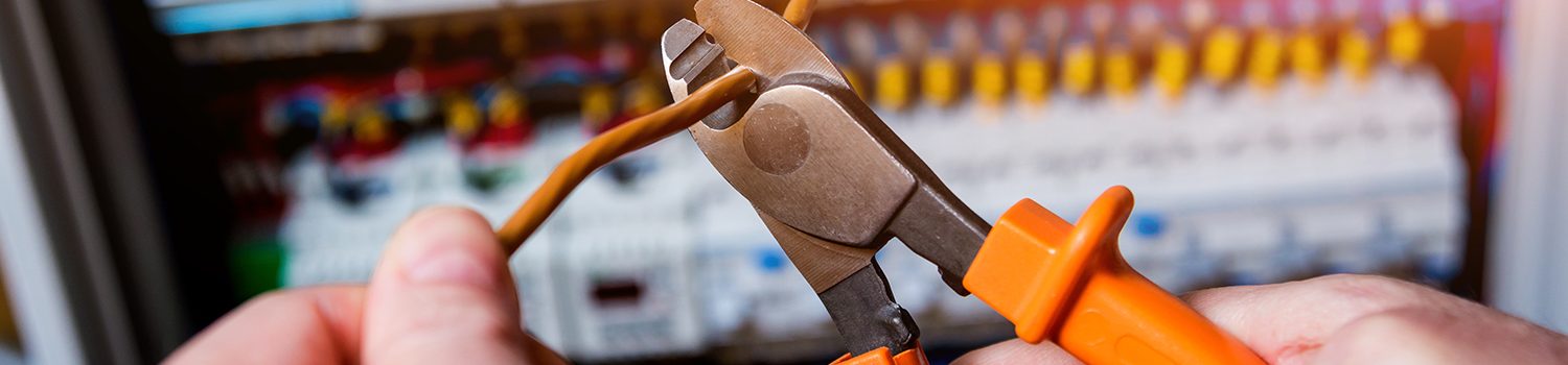 The man is repairing the switchboard voltage with automatic switches. The man is repairing the switchboard voltage with automatic switches. Electrical background